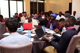RLO Actors attend a hbs-migration workshop Diverse people seated around tables with laptops