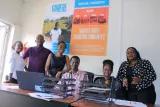 Group photo of colleagues behind a desk